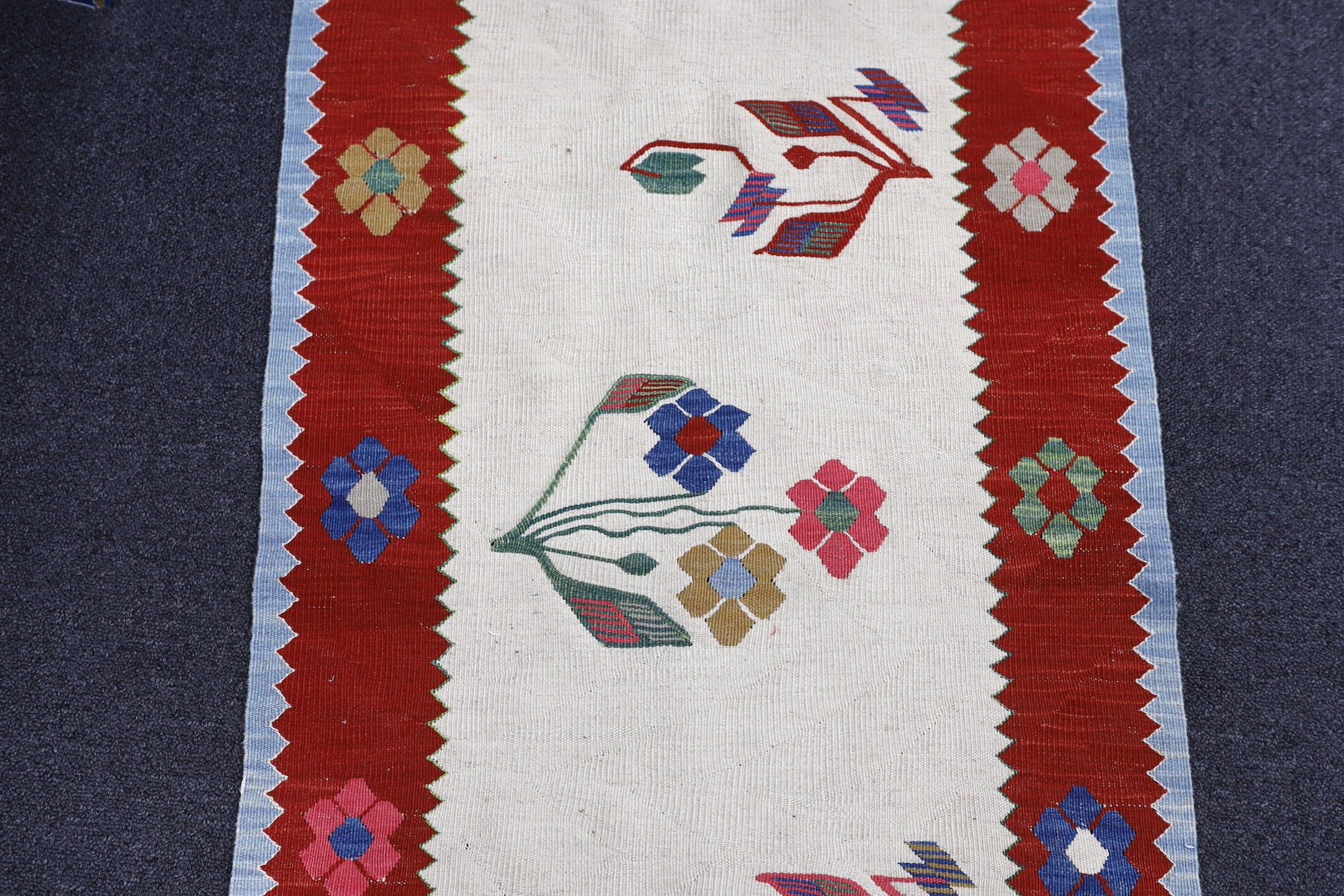 A Turkish floral mat, 100 x 60cm